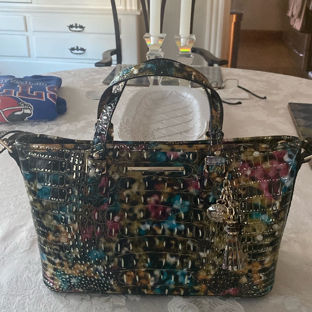 This a shoulder handbag made by Brahmin. It is a multi-color leather bag.